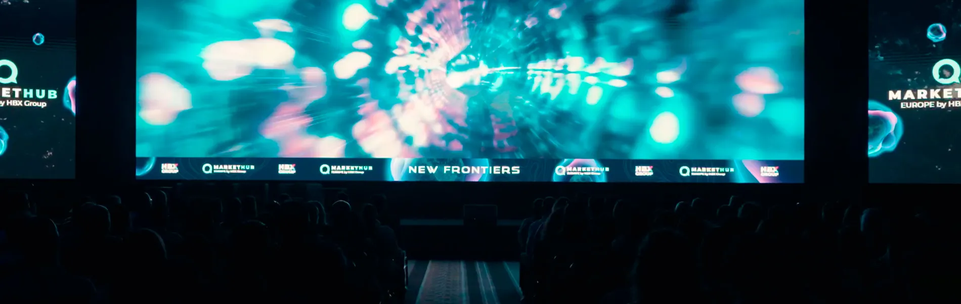 Stage screen with text new frontiers