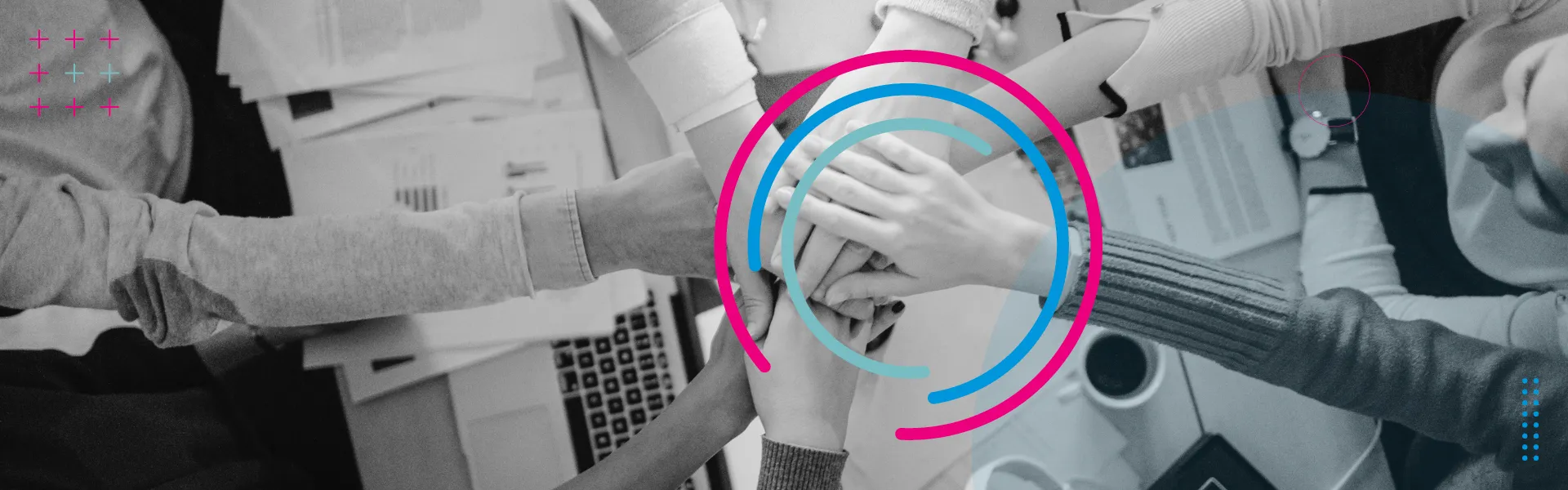 Overhead shot of many hands together over an office desk