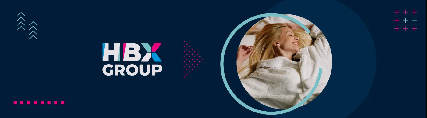 A blue background with the text HBX GROUP and a circular image of a woman laying on a bed in a towel robe