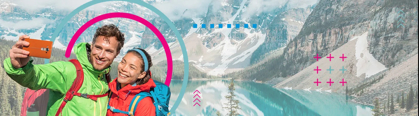 A mountain and lake with 2 travellers taking a selfie in front with HBX Group Branding