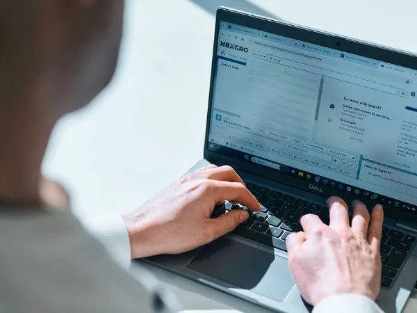 A person typing into a laptop