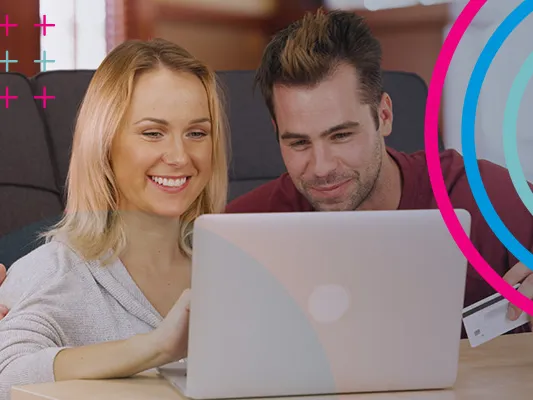 A couple viewing a laptop in a cafe