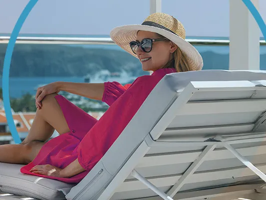 A lady on a deck chair by the pool